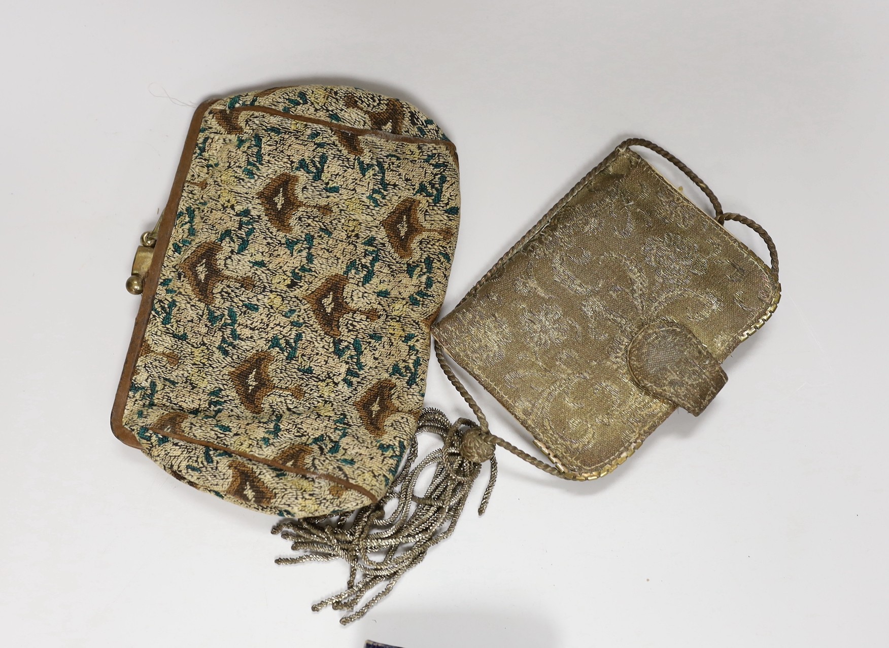 A suitcase containing a collection of late 19th century leather sewing bags and containers, wooden darning mushrooms, etc